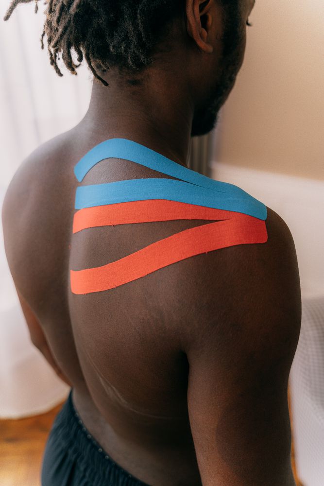 African athlete receiving therapeutic support for sports recovery